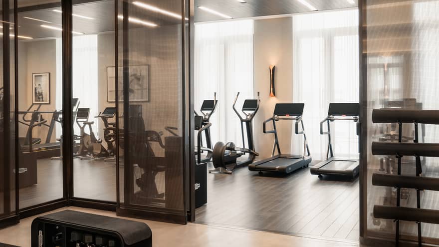 A Fitness Centre with exercise machines along the wall facing the windows