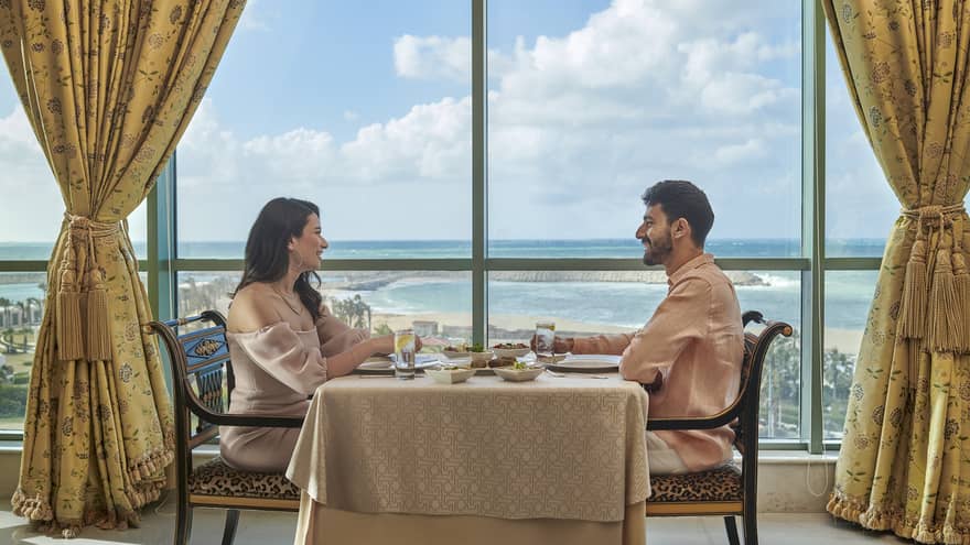 Couple enjoys a meal at Byblos Restaurant with views of the Mediterranean Sea