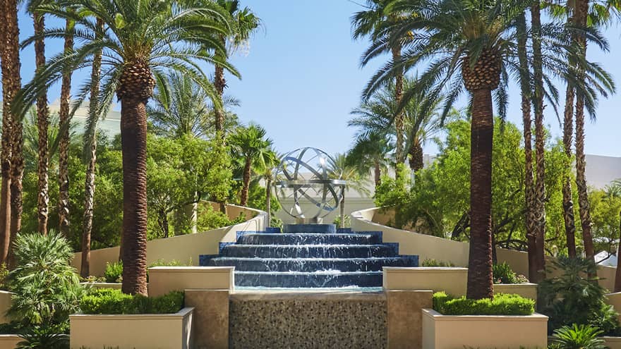 Tall palm trees over large fountain and sunny courtyard at Four Seasons Hotel Las Vegas