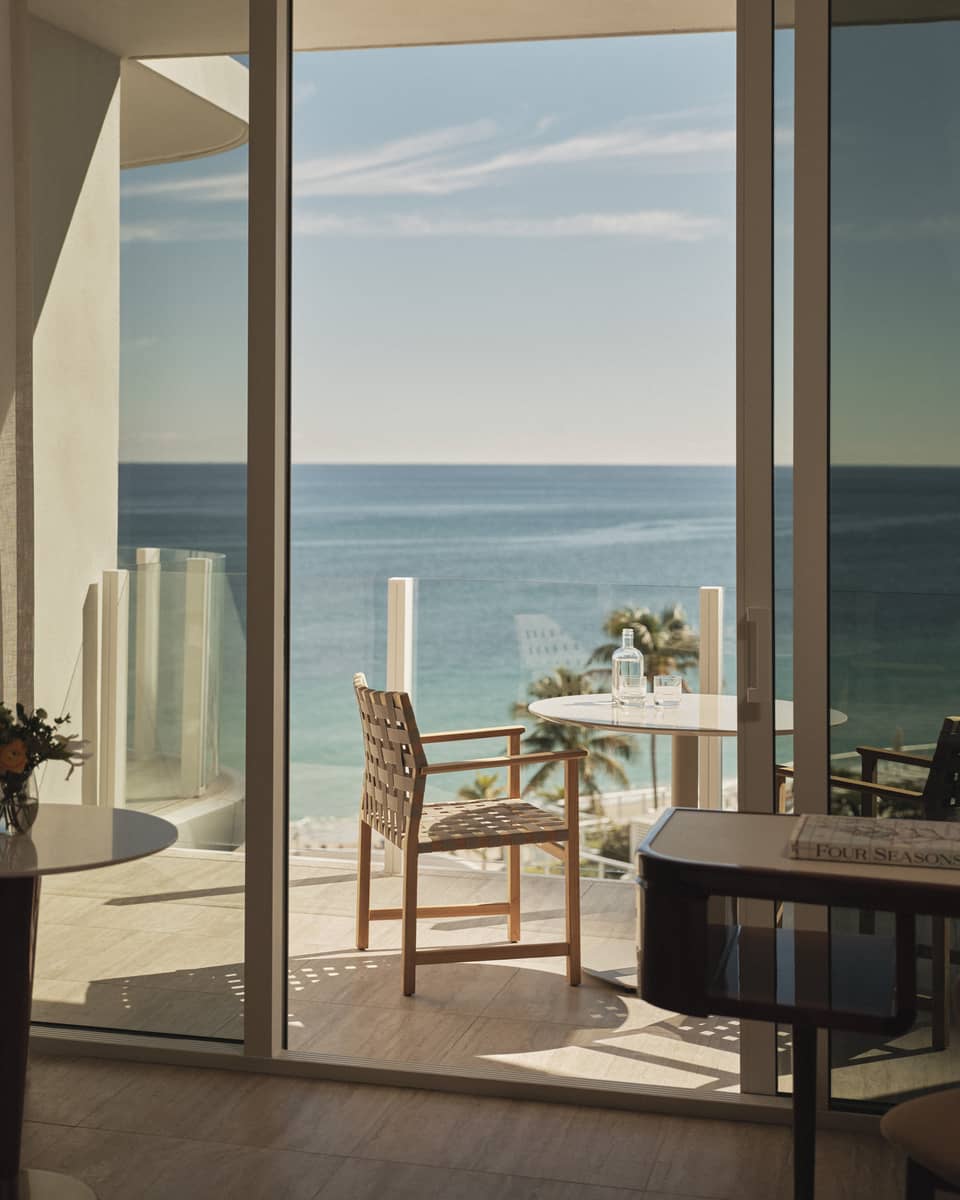 Hotel room glass balcony overlooking ocean