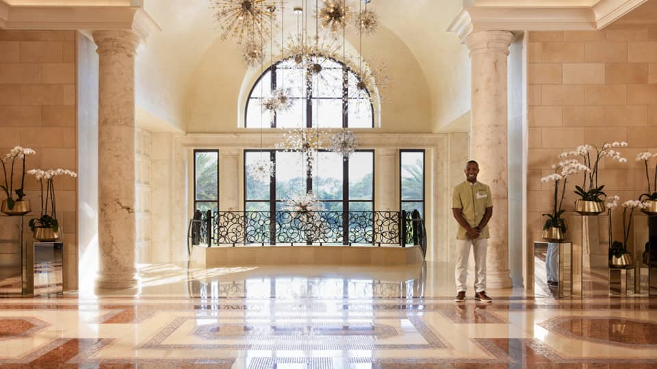 Hotel lobby with flowers and hanging lights.