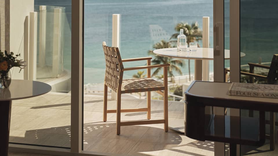 Hotel room glass balcony overlooking ocean