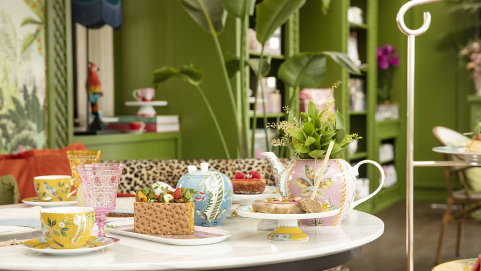 Round table with colourful tea cups and sweets at YASEMIN