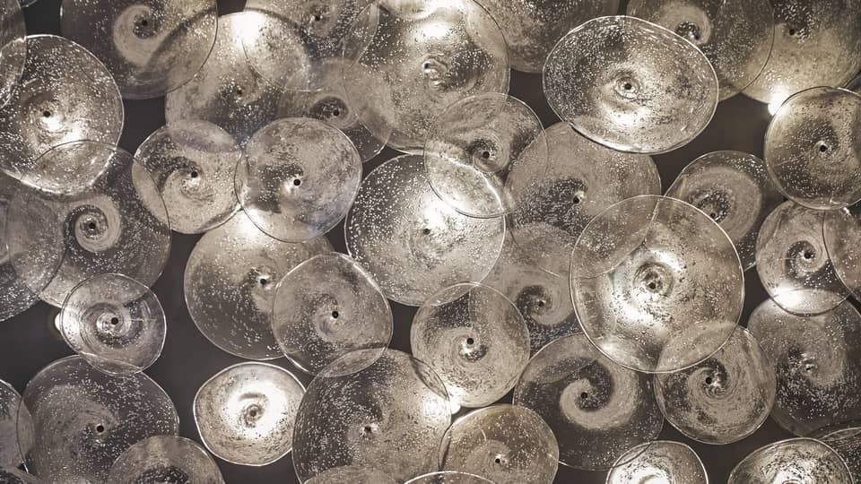 Glass sculptures, clear discs with swirls