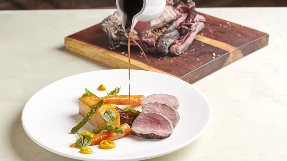 Glaze drizzled on slices beef filet dish