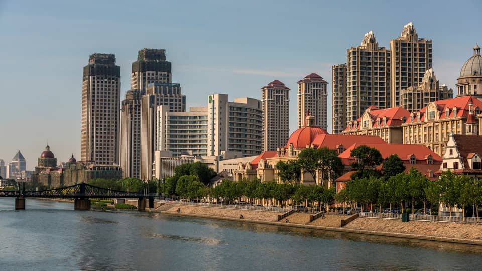 Walkway along banks of Hia River, bridge, Tianjin skyline