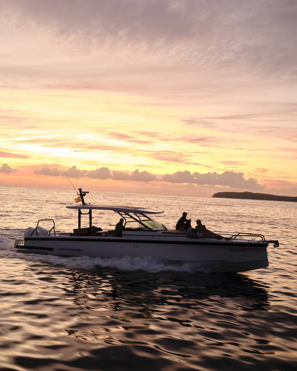 A boat on the water at sunset in island destination