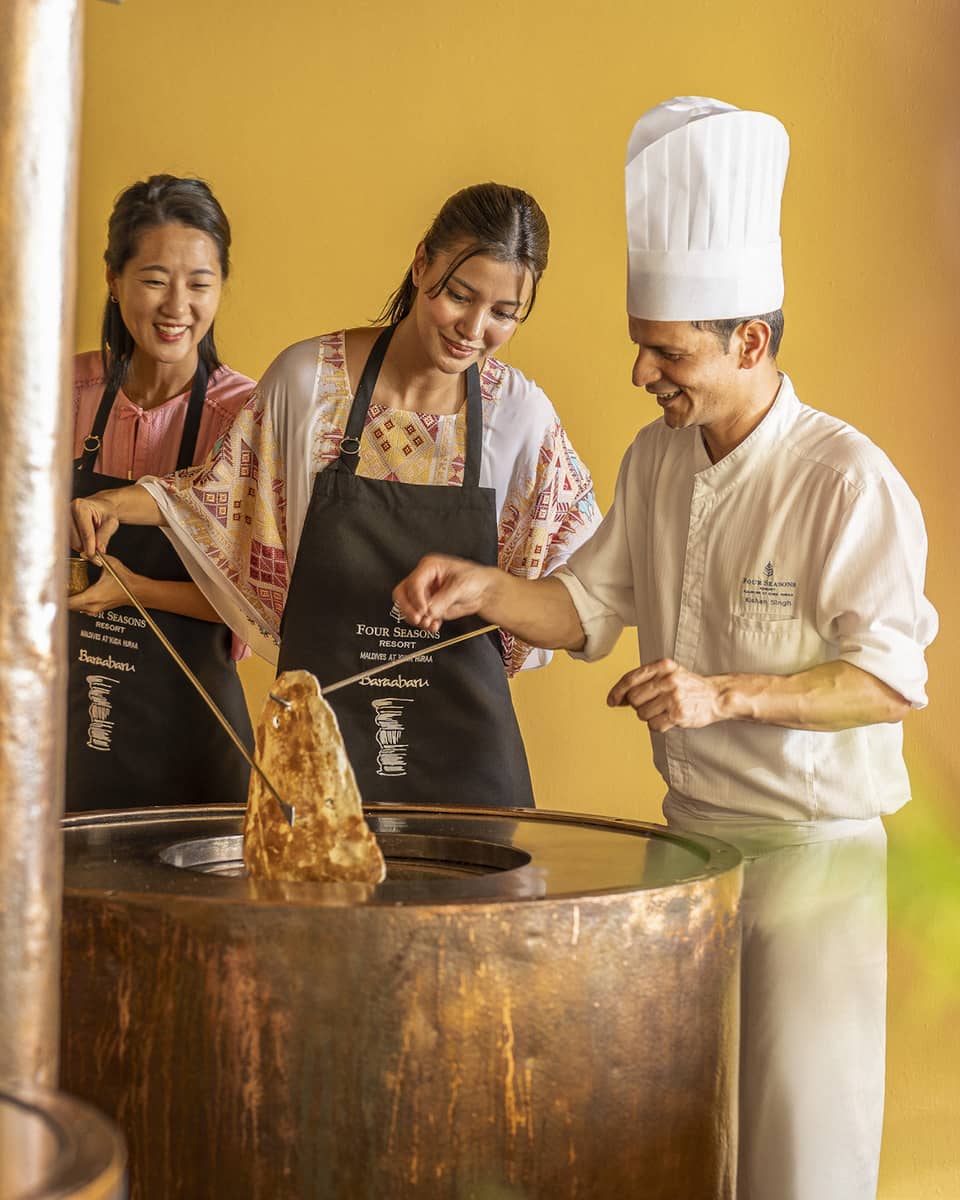 Chef teaches two female guests during Indian cooking class at Baraabaru