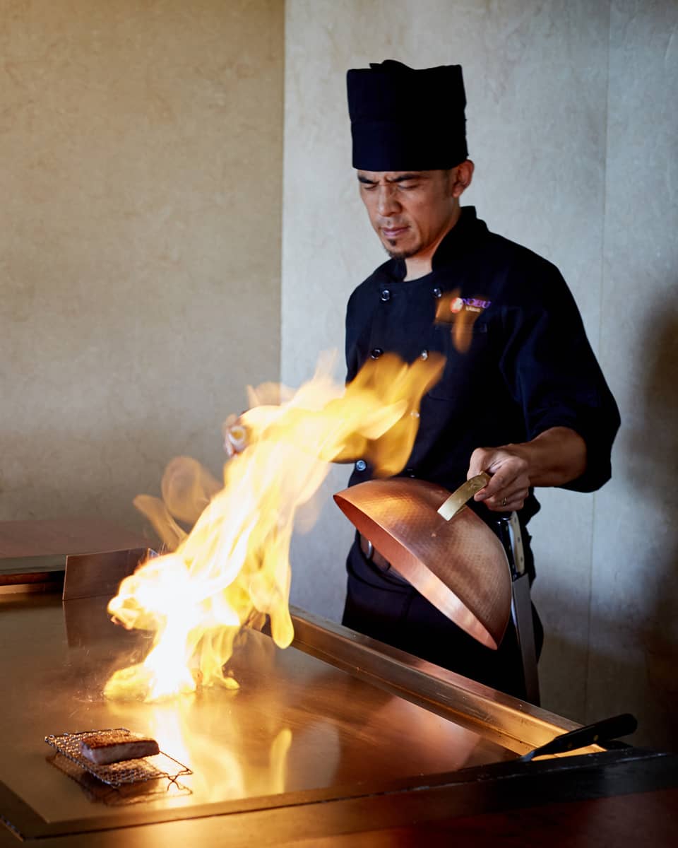 Flames shoot up from grill as NOBU restaurant chef pulls back copper lid