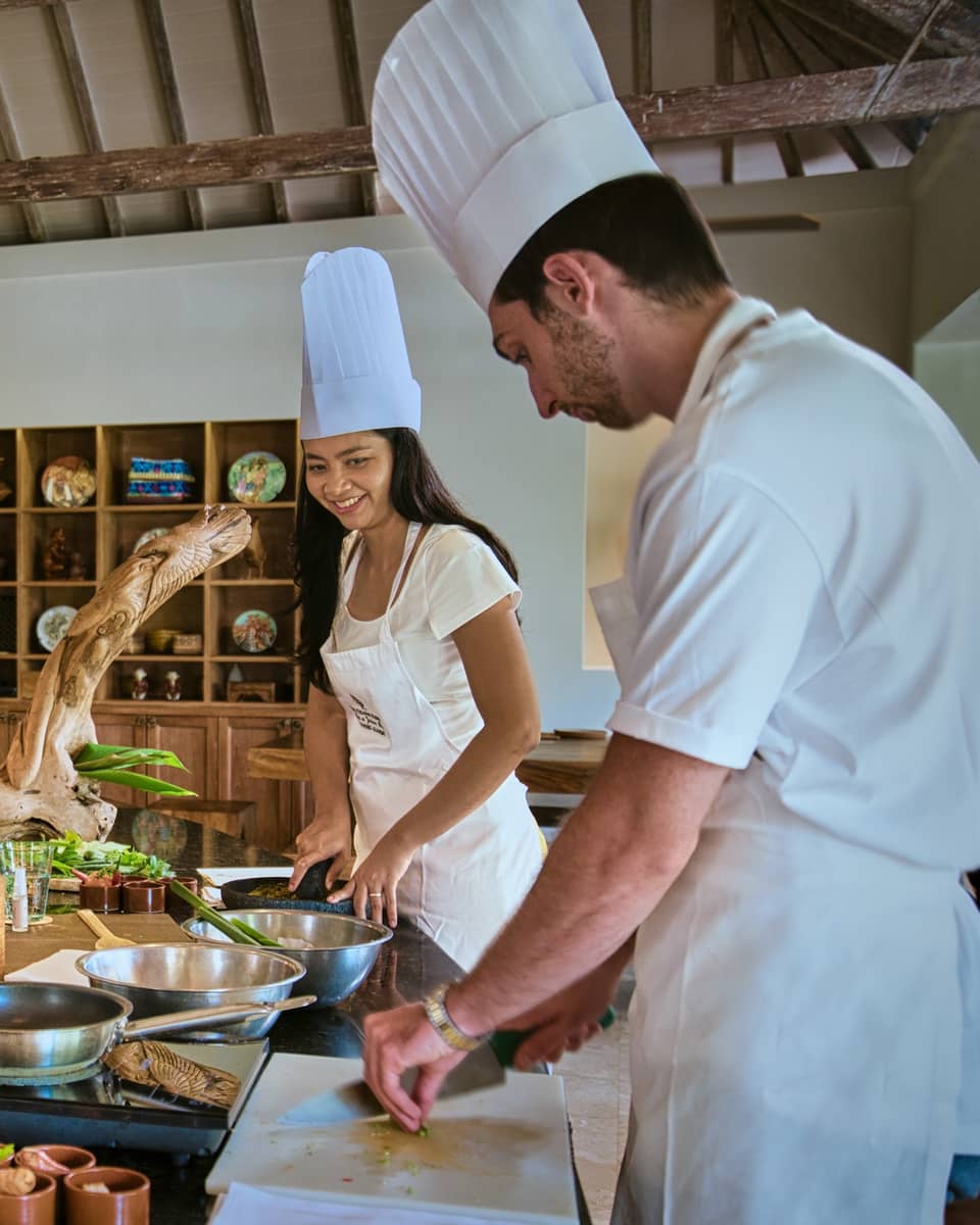 Two guests receive cooking lesson at Four Seasons hotel