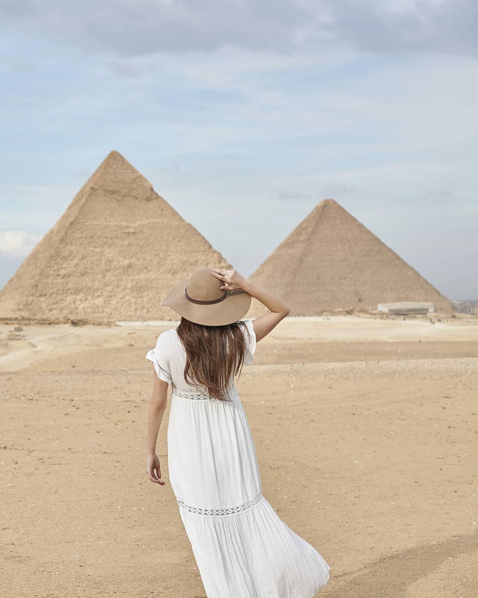 A guest wearing a linen dress observing the Great Pyramids