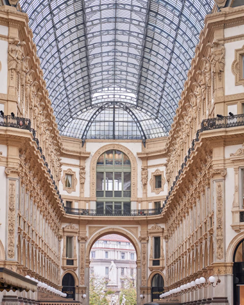 Historic Milan buildings and shops under glass vaulted ceiling