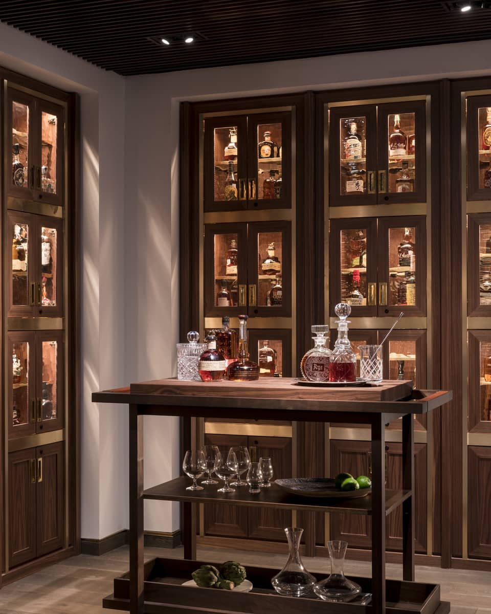 Various whiskey, bourbon, crystal bottles on bar