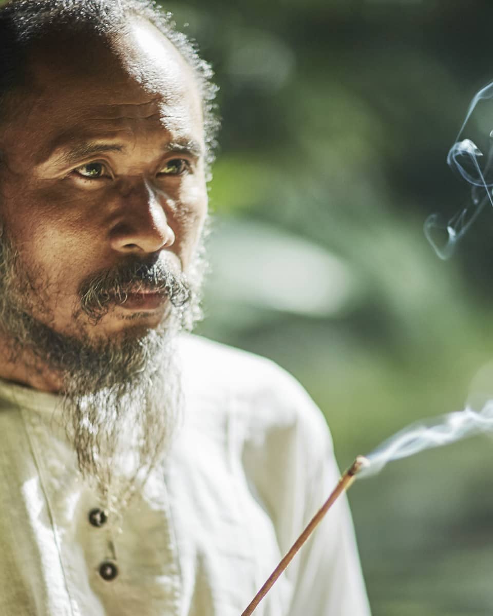 Balinese healer with burning incense