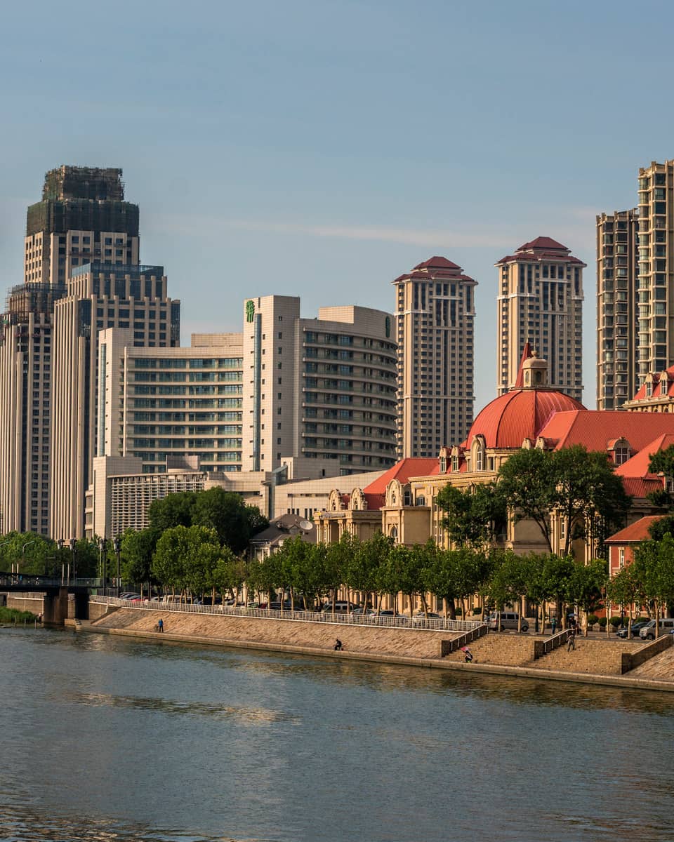 Walkway along banks of Hia River, bridge, Tianjin skyline