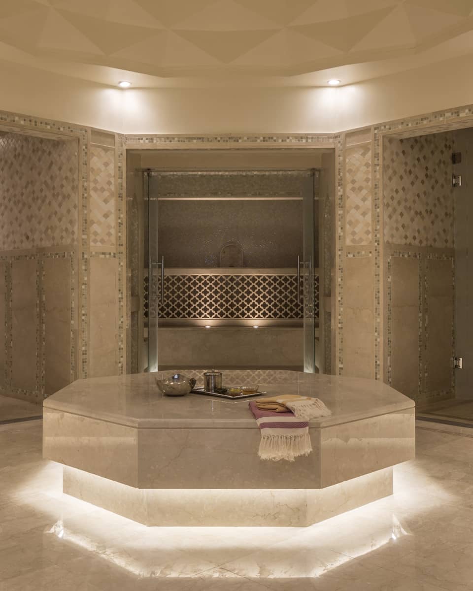 Hammam room with illuminated under lighting, beige marble