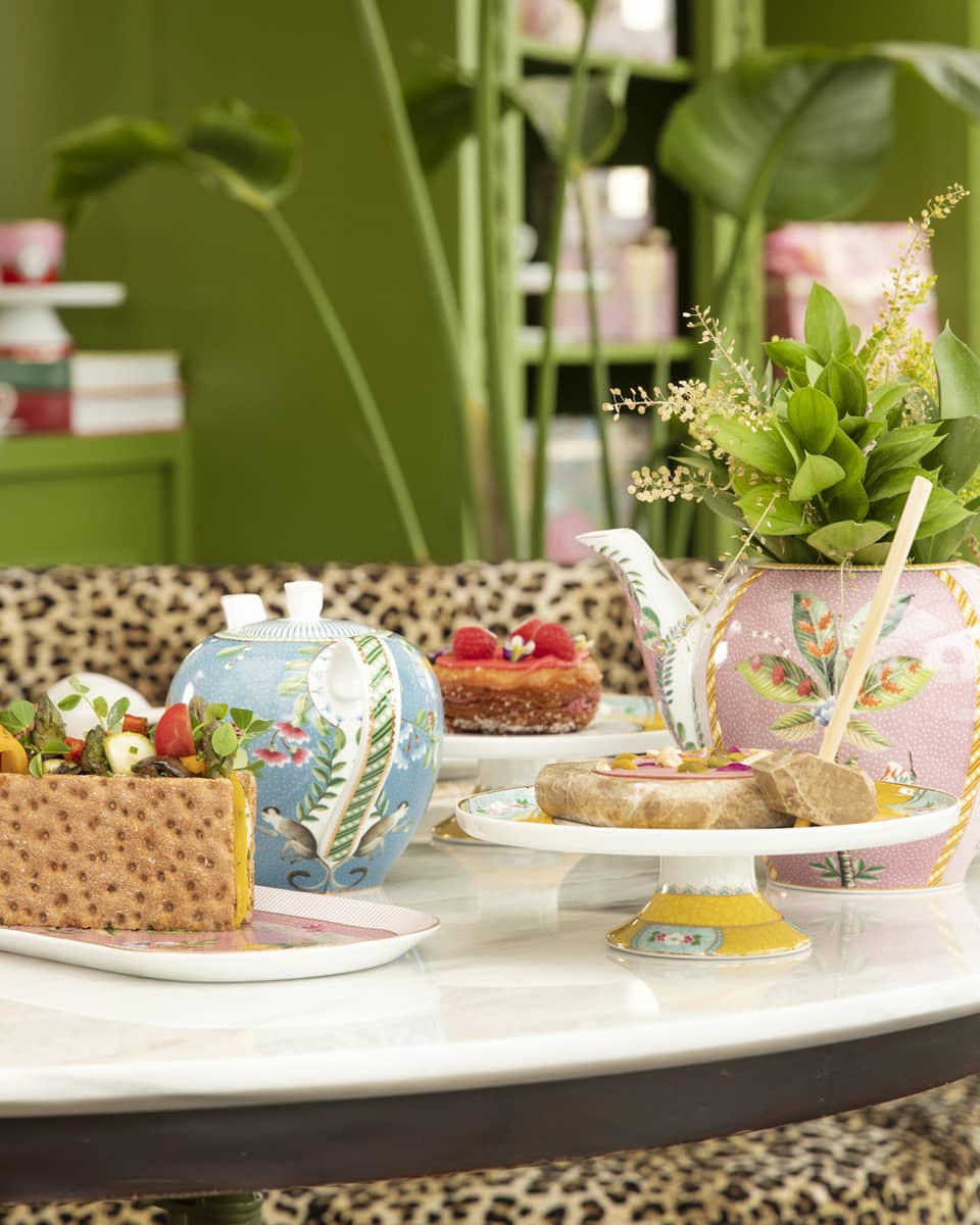 Round table with colourful tea cups and sweets at YASEMIN