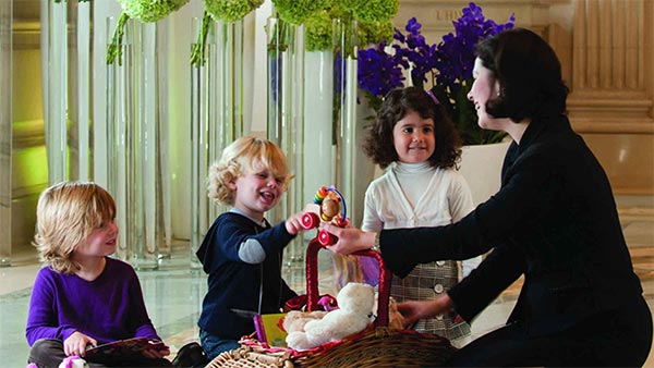 Recreations Manager at Four Seasons Hotel George V, Paris greets three children—Paris, France