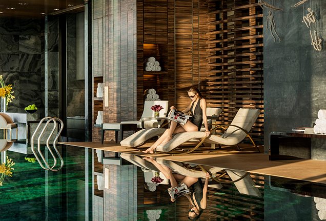 Woman relaxing by infinity pool at Four Seasons Shanghai Pudong Flare Spa Pool