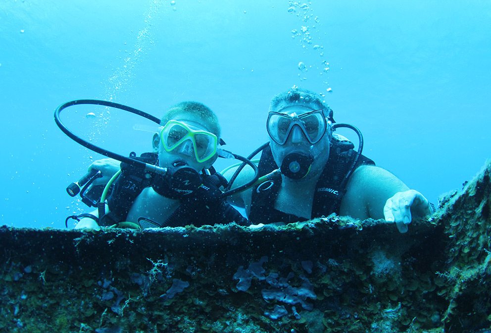 Talon Windwalker scuba diving on vacation with his teenage son