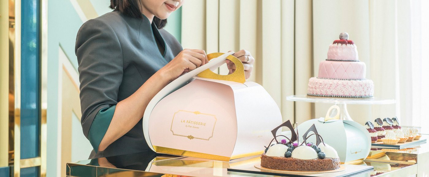 Woman closing box at La Patisserie