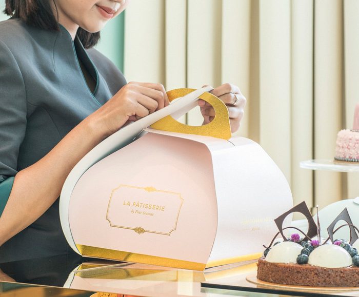 Woman closing box at La Patisserie