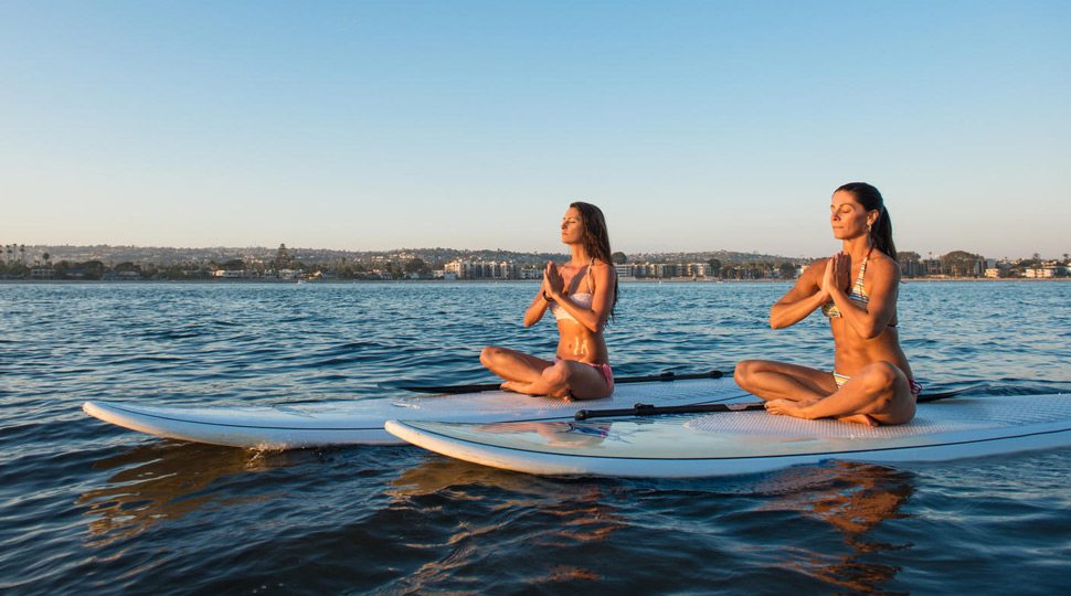 Two women paddleboarding