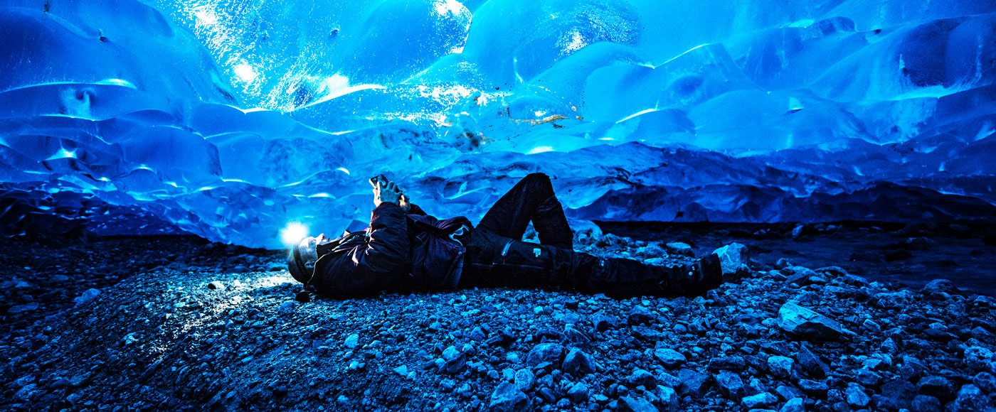 Man laying in ice cave