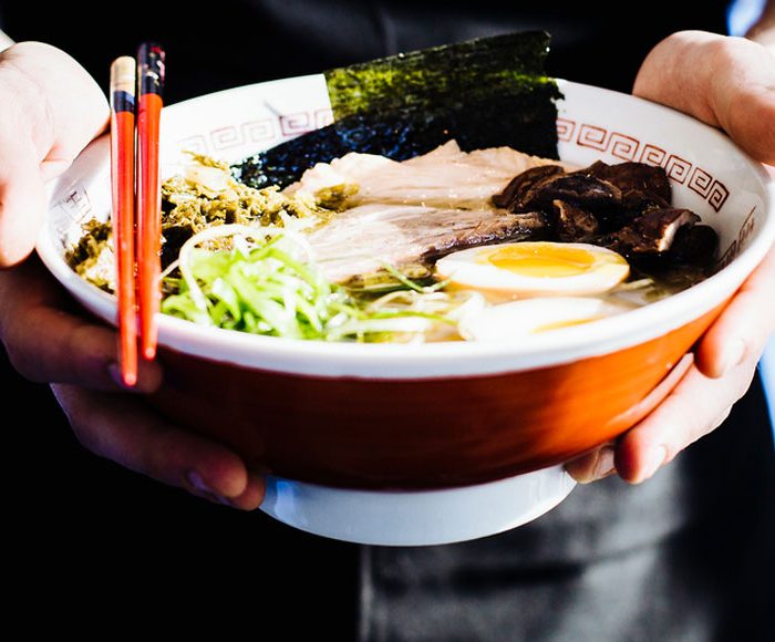 Man holds ramen bowl in Japan