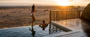 Photographer Robert Michael Poole and his partner, Marcy Yu, enjoying sunset at their private infinity pool at Four Seasons Safari Lodge Serengeti.