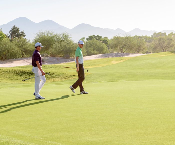 Two golfers walking the course