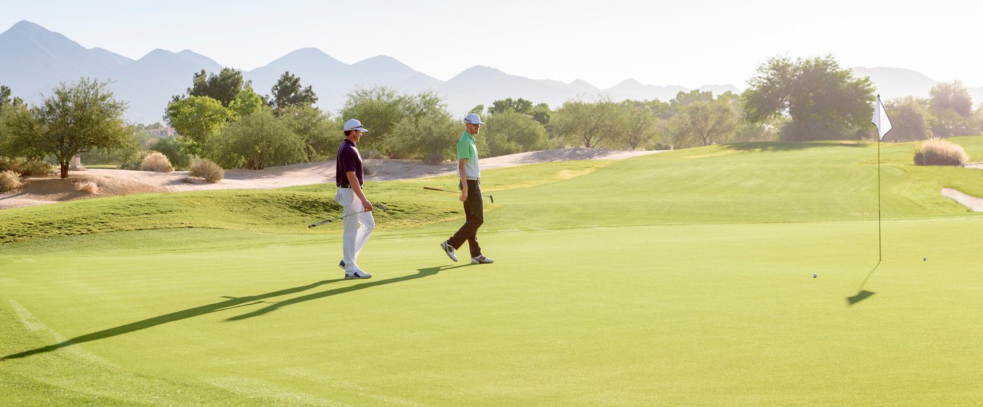 Two golfers walking the course