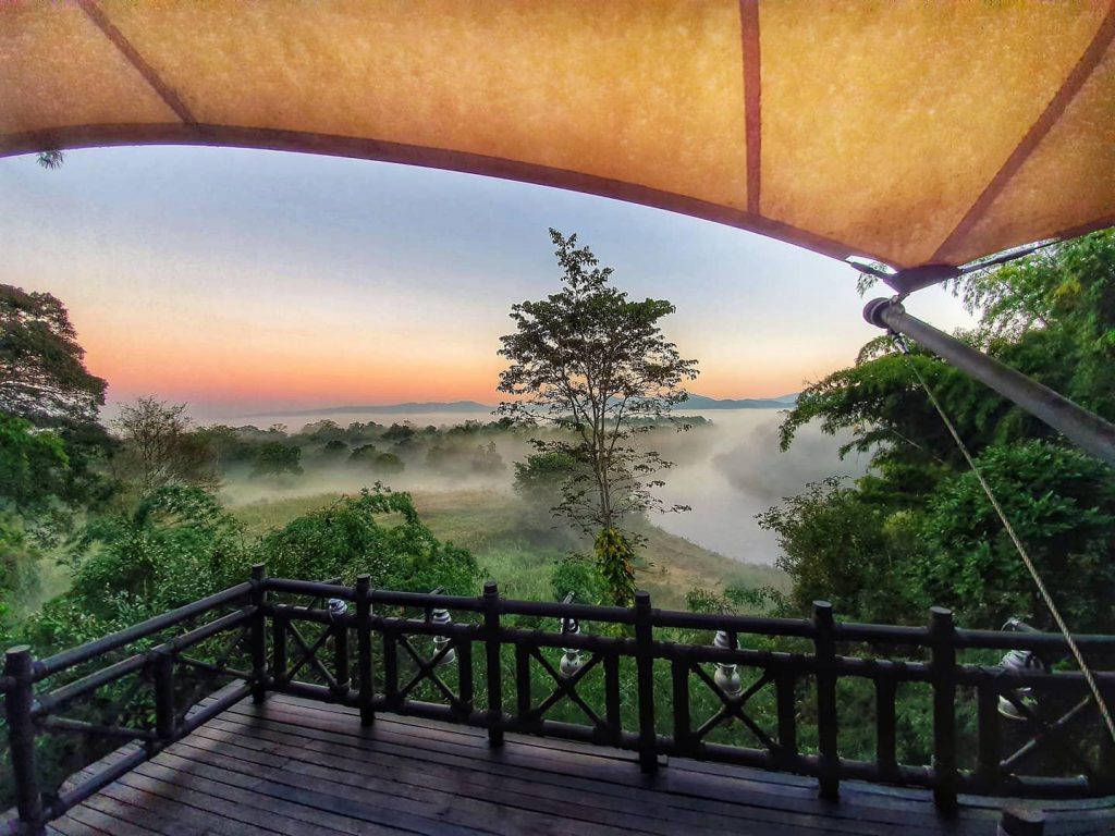 Golden Triangle balcony with view of sunrise and jungle with fog