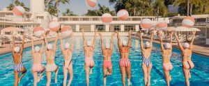 Group of women jump into a pool