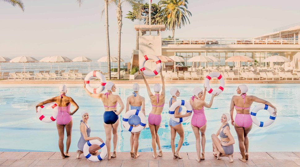 Women poolside with lifesavers