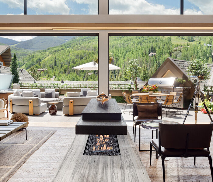 Mountain view from the large windows of a chic, modern living area
