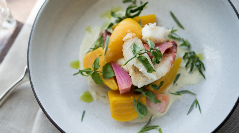 Beet & dungeoness crab salad on a white plate