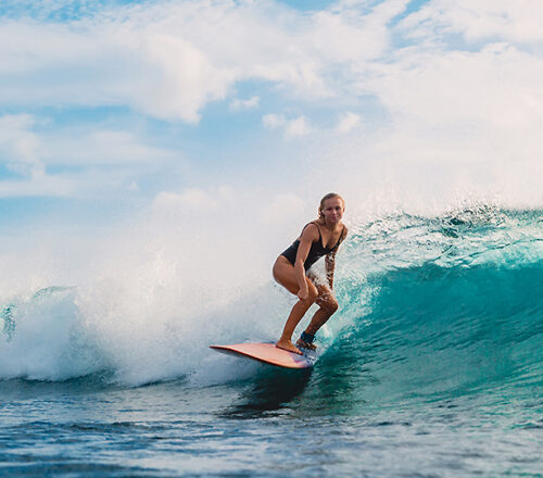 Surf Girl On Surfboard. Woman In Ocean During Surfing. Surfer And Ocean Wave