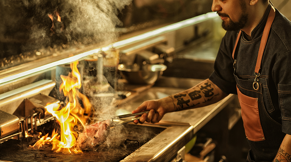 Side,view,of,professional,chef,cooking,delicious,juicy,beef,steak