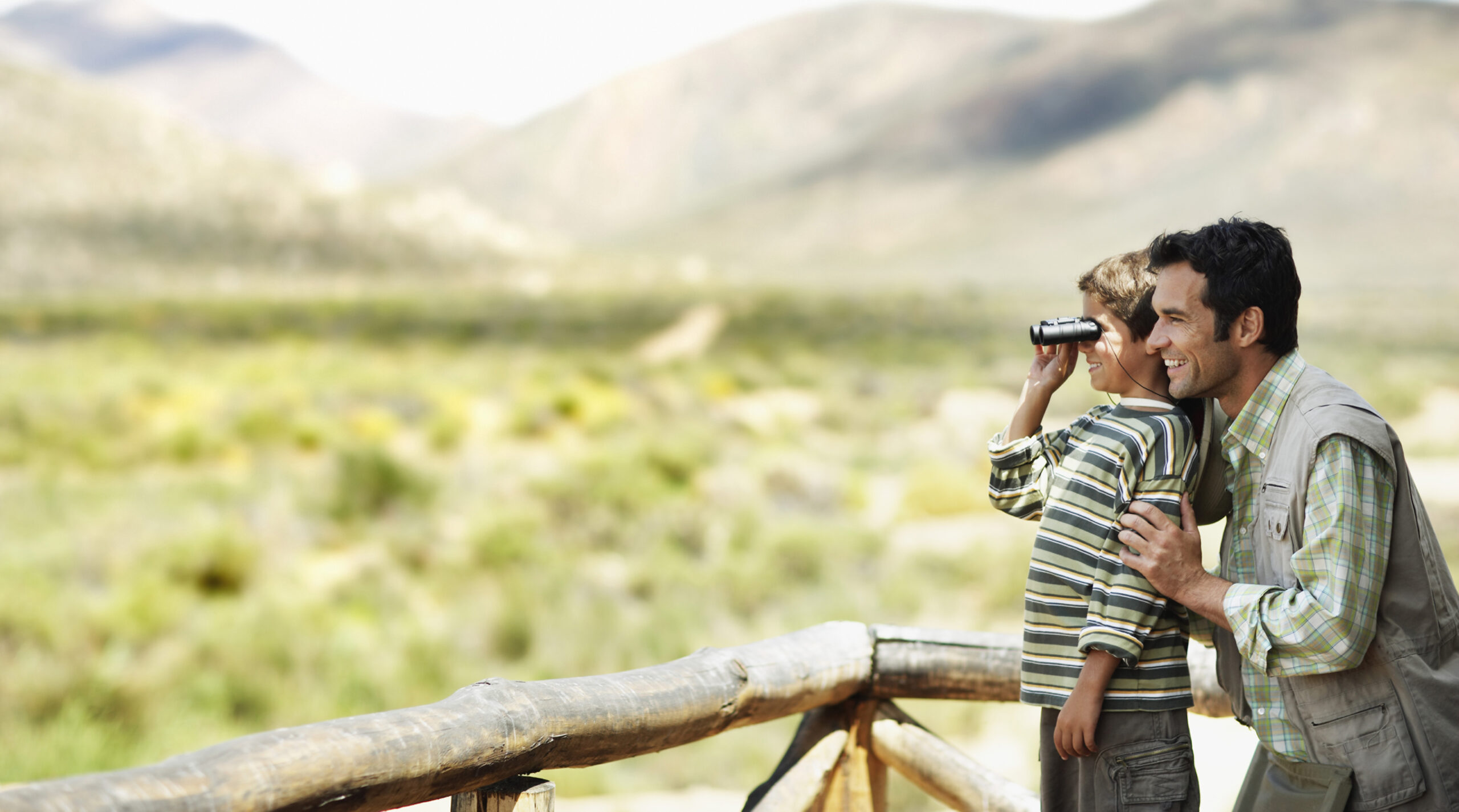 Father And Son Using Binoculars