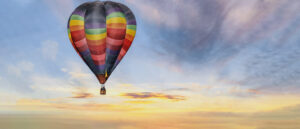 Hot Air Balloon In Colorful Sunrise Sky