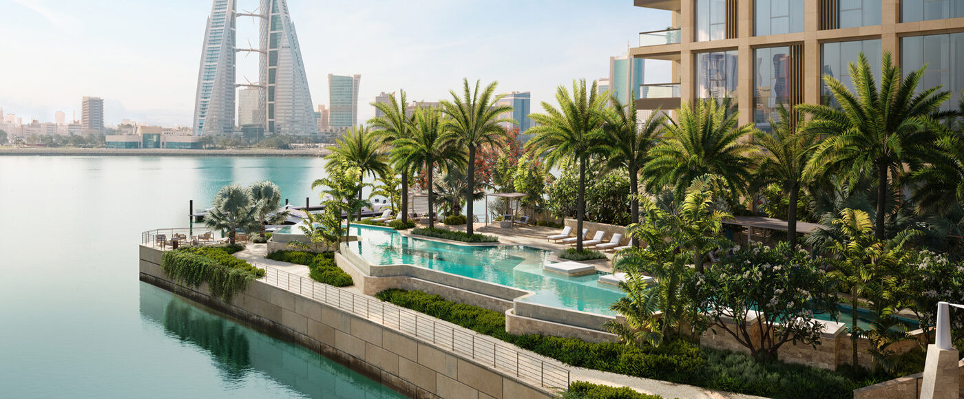 Palm-fringed outdoor pool set on a terrace next to the river