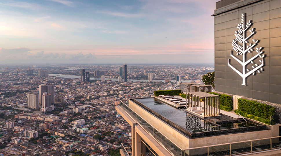 Outdoor pool set on a rooftop terrace overlooking Bangkok