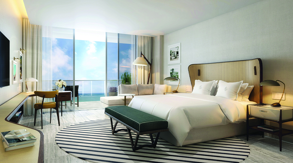 Bedroom with king-size bed, curved headboard, green bench, black-and-white striped round rug, mid-century furnishings and floor-to-ceiling glass doors that open onto a private terrace