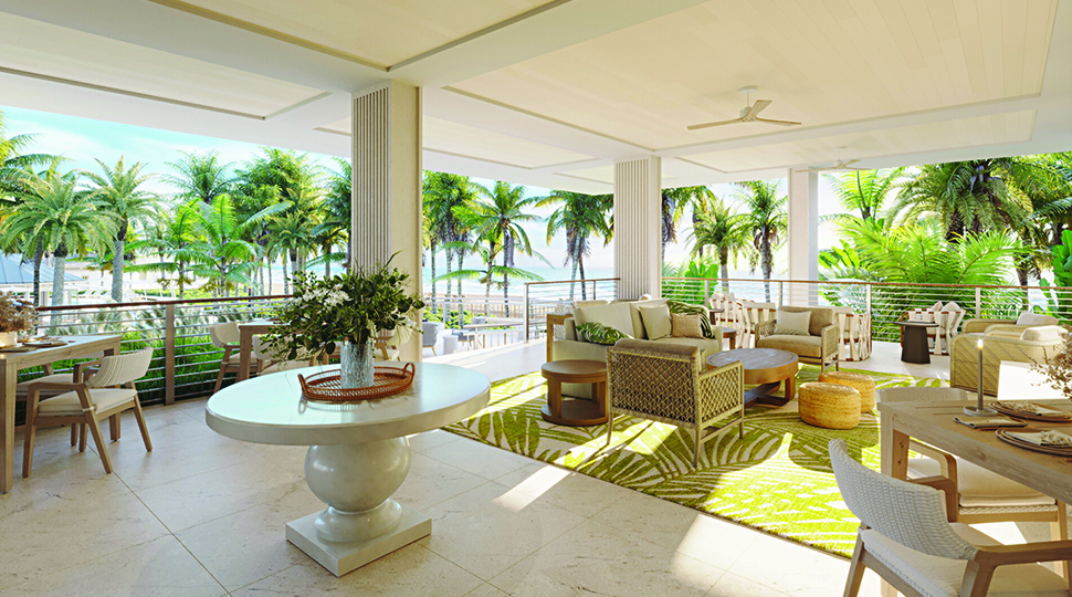 Open-air lounge area with various seating options and palm trees in the distance
