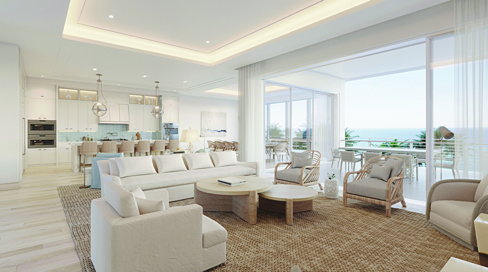 Living room decorated in white and beige that opens up onto a large outdoor terrace