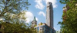 View of downtown New York skyscraper and buildings framed by trees in the summer