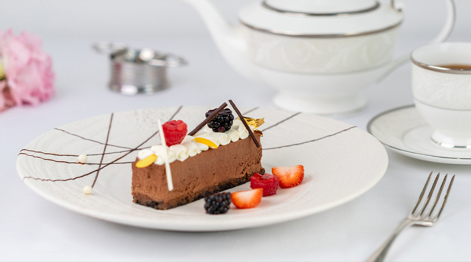 Torroncino & Gianduja made with hazelnut gianduja royaltine and seasonal berries served on a white plate