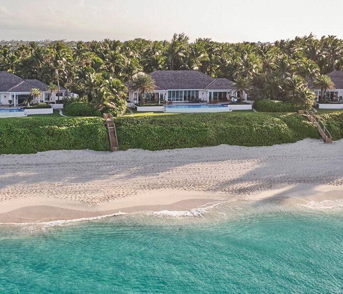 Three beachfront villas line the shore
