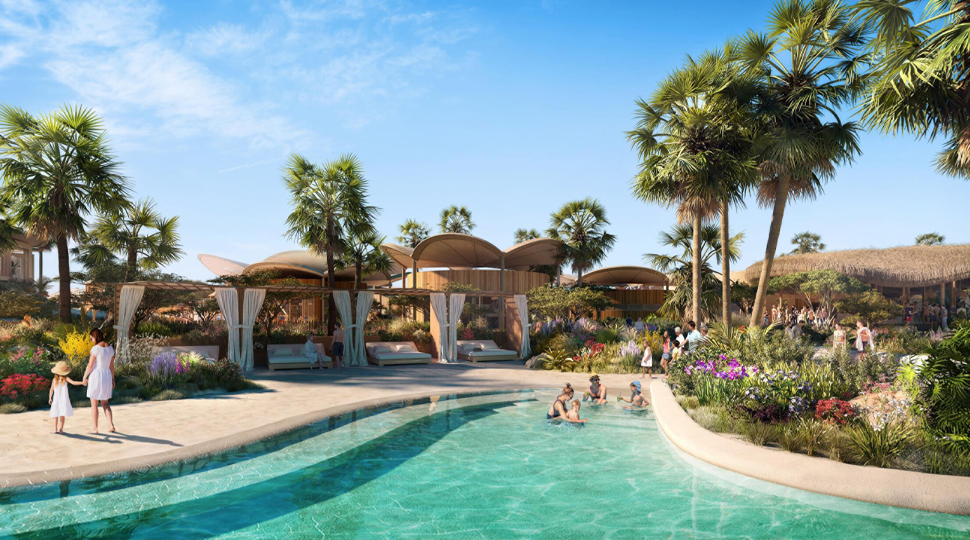 Family sits in shallow end of pool next to cabanas
